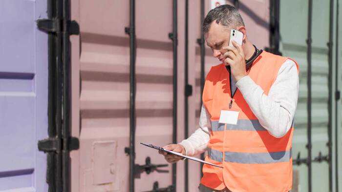 Dubai customs clearing agent speaking on the phone